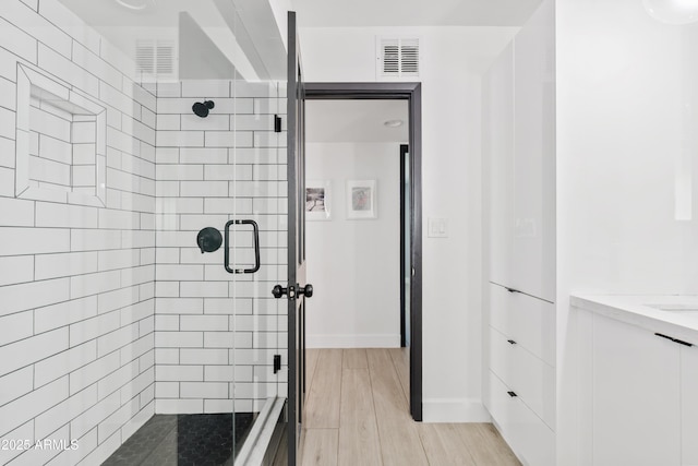 101 E Linger Ln, Phoenix, AZ 85020 - full bathroom with a stall shower, wood finished floors, and baseboards