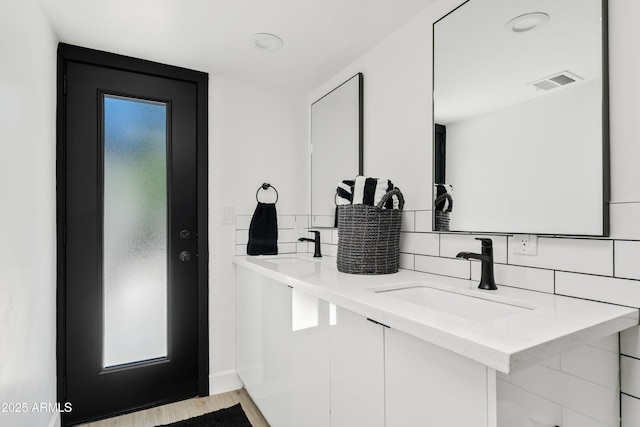 101 E Linger Ln, Phoenix, AZ 85020 - bathroom with decorative backsplash, double vanity, and wood finished floors