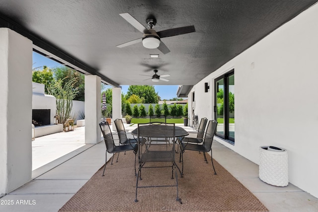 101 E Linger Ln, Phoenix, AZ 85020 - view of patio / terrace featuring an outdoor fireplace, outdoor dining area, a fenced backyard, and ceiling fan
