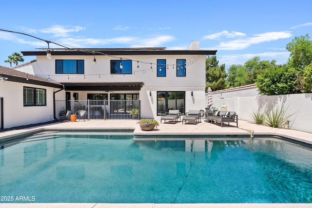 101 E Linger Ln, Phoenix, AZ 85020 - rear view of property featuring a patio area, stucco siding, fence, and an outdoor hangout area