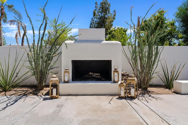 101 E Linger Ln, Phoenix, AZ 85020 - view of patio with an outdoor fireplace and fence