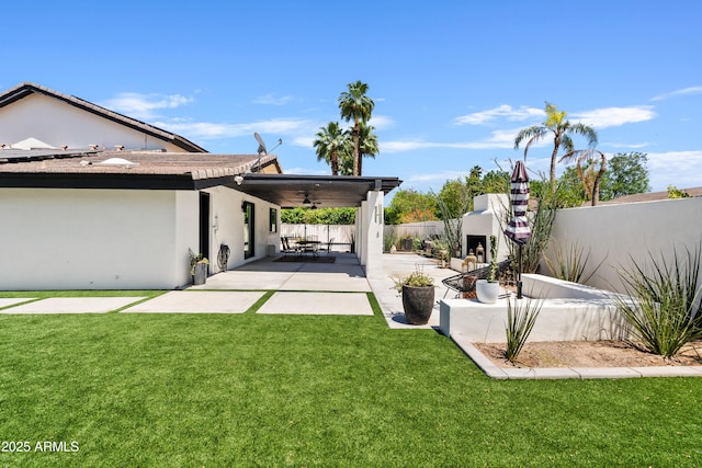 101 E Linger Ln, Phoenix, AZ 85020 - view of yard featuring a ceiling fan, a patio area, and a fireplace
