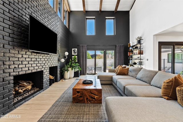 101 E Linger Ln, Phoenix, AZ 85020 - living area with a towering ceiling, a fireplace, beam ceiling, and wood finished floors