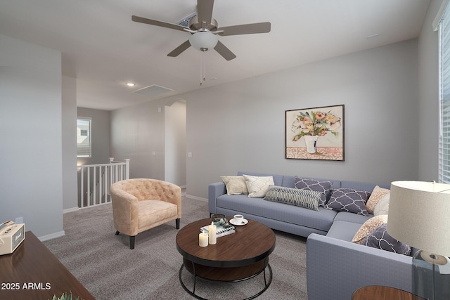 carpeted living room featuring baseboards