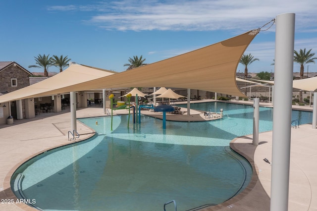 pool with a patio area and fence