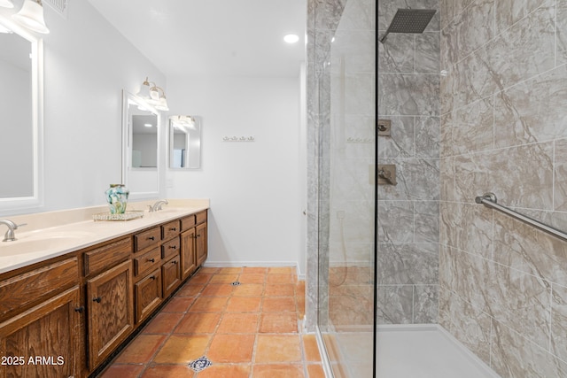 bathroom featuring vanity, tile patterned floors, and tiled shower