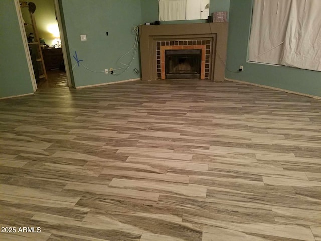 unfurnished living room featuring hardwood / wood-style flooring and a fireplace