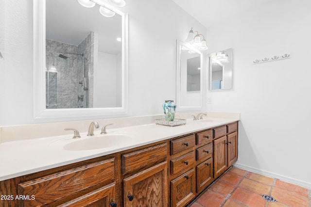 bathroom featuring vanity, a tile shower, and tile patterned floors