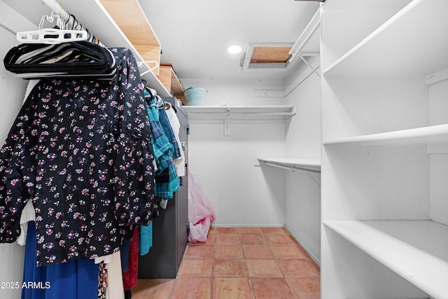 spacious closet with tile patterned floors