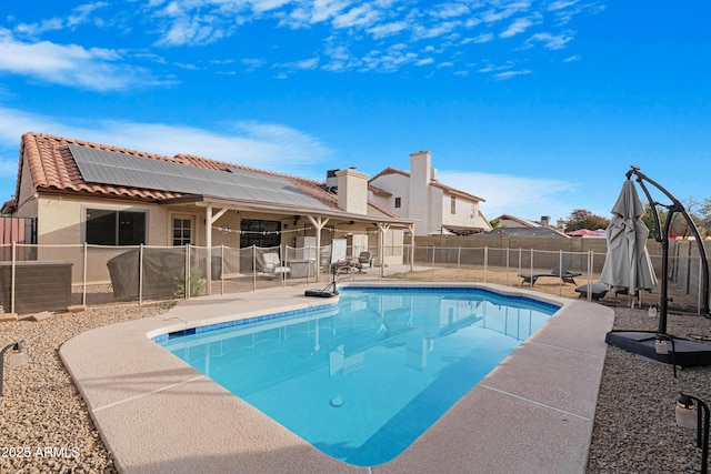 view of swimming pool with cooling unit and a patio area