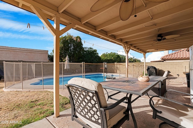 view of patio / terrace with a fenced in pool and ceiling fan