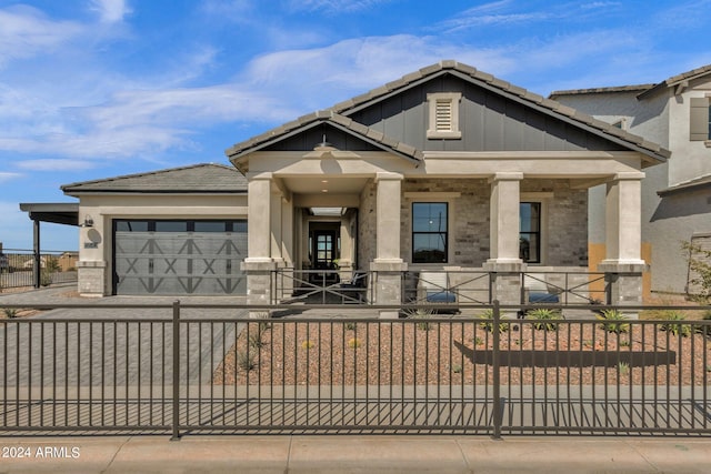 view of front of property with a porch and a garage