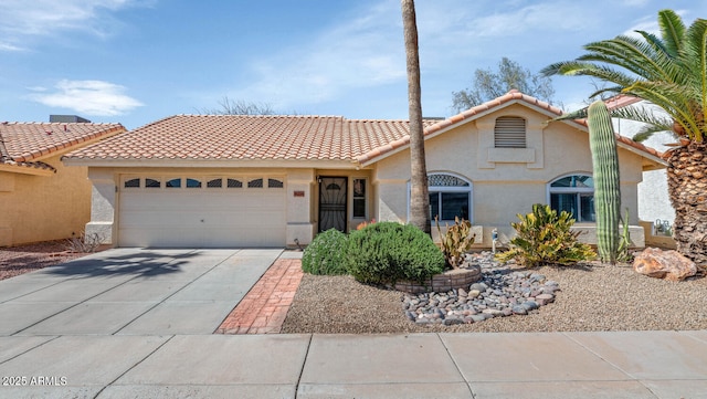 view of front of property with concrete driveway, an attached garage, and stucco siding