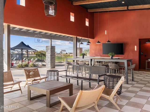 view of patio / terrace with fence and a bar