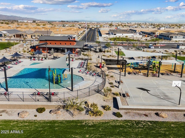 drone / aerial view of a mountain backdrop and a pool