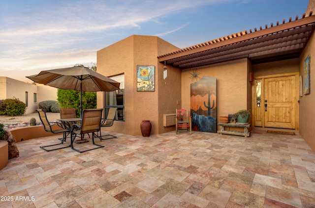 view of patio terrace at dusk