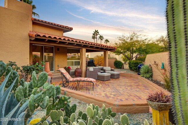 patio terrace at dusk with an outdoor living space