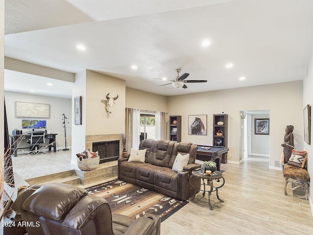 living room featuring ceiling fan and light hardwood / wood-style flooring