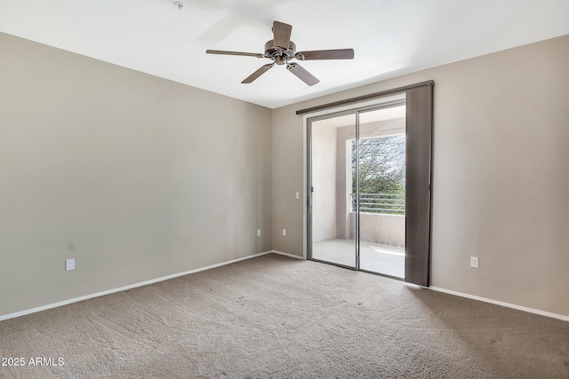 carpeted empty room featuring ceiling fan and baseboards