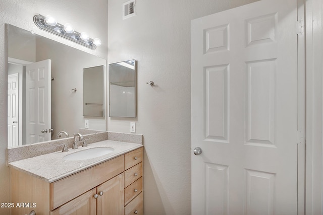 bathroom with visible vents and vanity