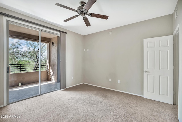 carpeted empty room with visible vents, a ceiling fan, and baseboards
