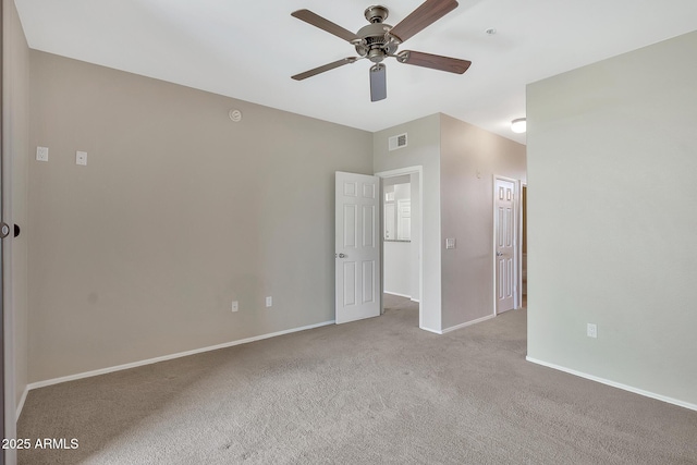 unfurnished bedroom featuring baseboards, visible vents, carpet flooring, and ceiling fan