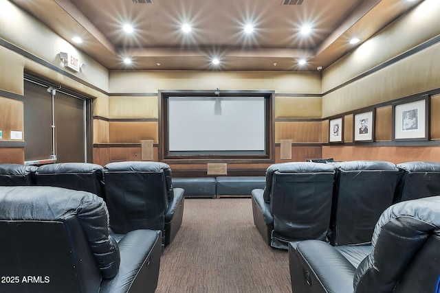 carpeted cinema room with recessed lighting, a raised ceiling, visible vents, and a high ceiling