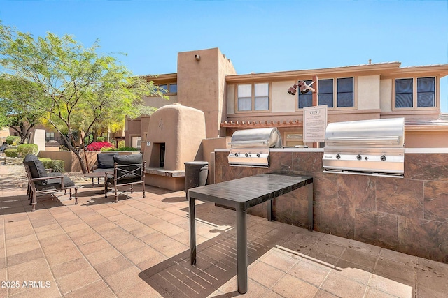 view of patio / terrace featuring exterior kitchen and grilling area