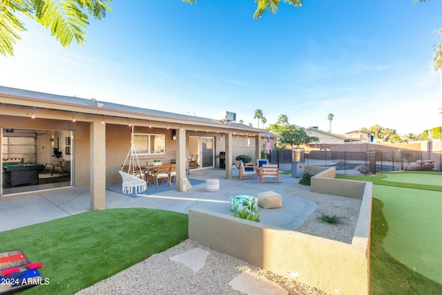 rear view of property with a patio area, outdoor dining space, fence, and stucco siding