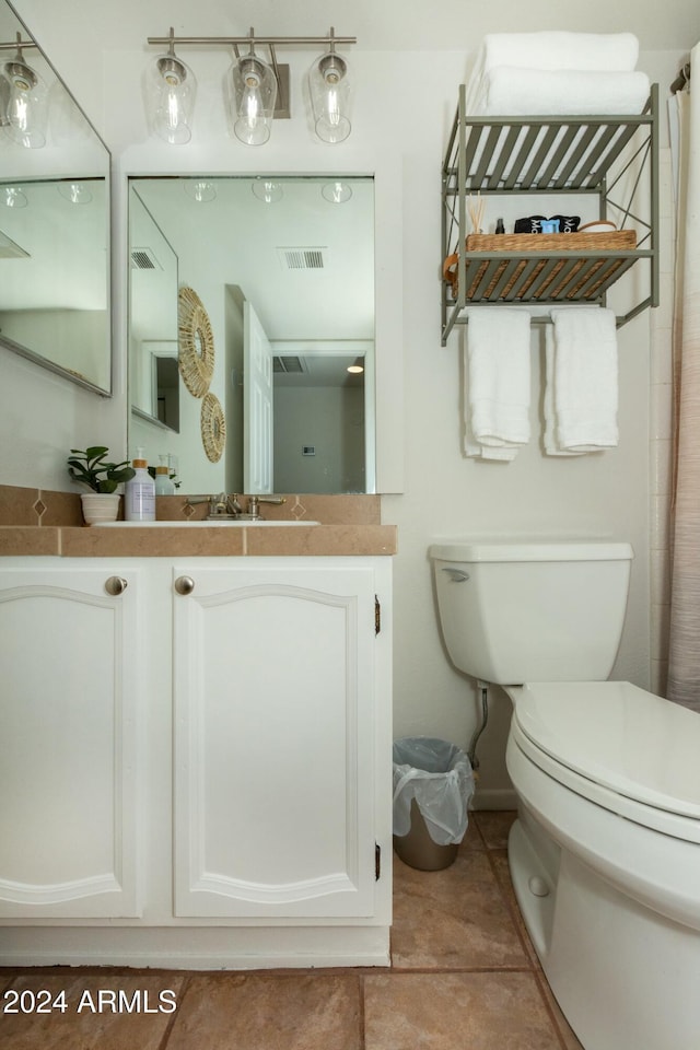 full bath with toilet, tile patterned floors, visible vents, and vanity