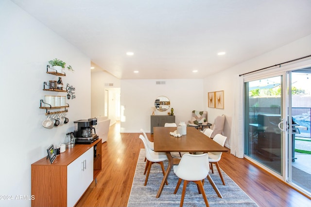 dining space featuring light wood-type flooring, visible vents, and recessed lighting