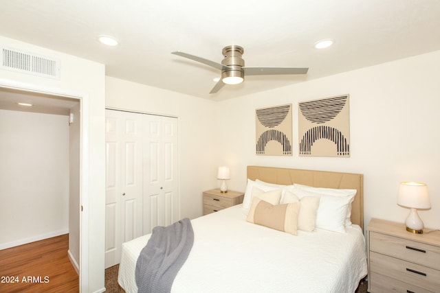 bedroom featuring baseboards, visible vents, wood finished floors, a closet, and recessed lighting