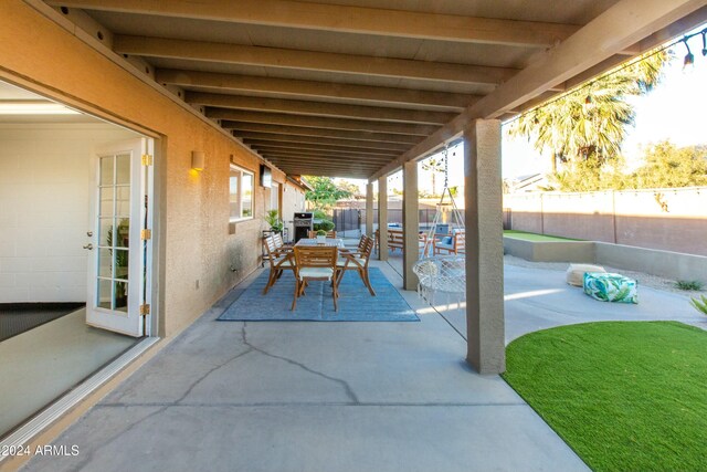 view of patio / terrace with outdoor dining area, a fenced backyard, and a grill