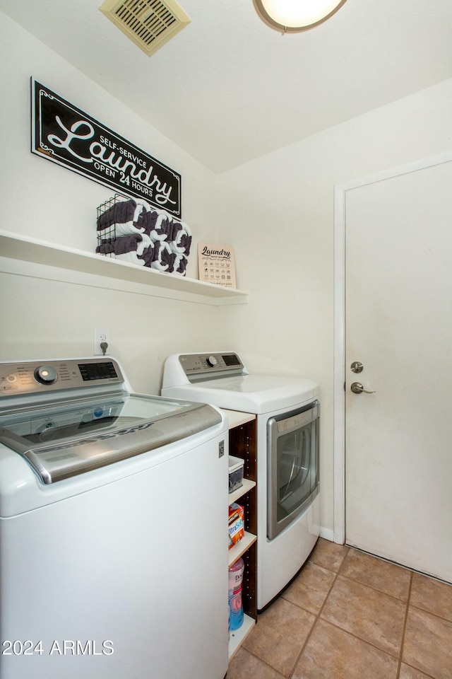 laundry area with light tile patterned floors, laundry area, washer and clothes dryer, and visible vents