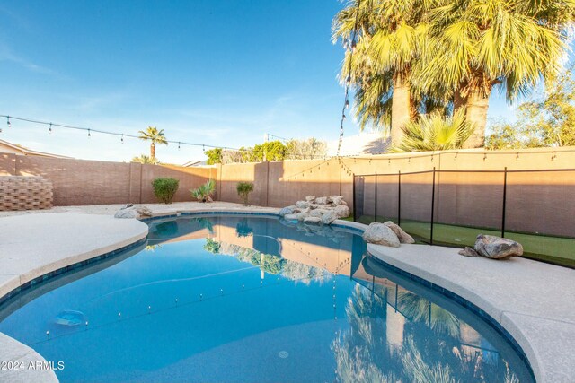 view of swimming pool featuring a fenced backyard and a fenced in pool