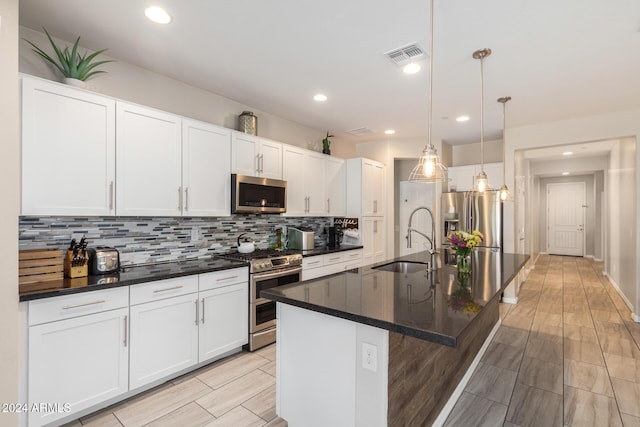 1952 N 212th Ln, Buckeye, AZ 85396 - kitchen with backsplash, visible vents, appliances with stainless steel finishes, a sink, and white cabinetry