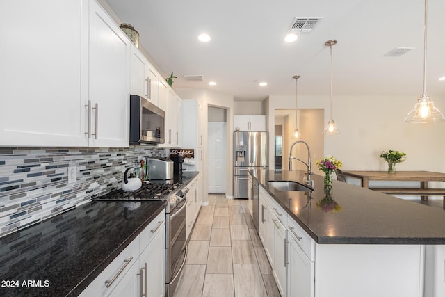 1952 N 212th Ln, Buckeye, AZ 85396 - kitchen featuring appliances with stainless steel finishes, a sink, an island with sink, backsplash, and visible vents