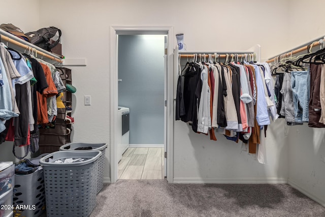 spacious closet featuring light carpet