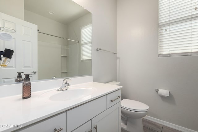 1952 N 212th Ln, Buckeye, AZ 85396 - bathroom featuring vanity, baseboards, walk in shower, and toilet