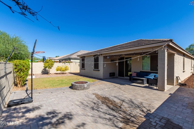 1952 N 212th Ln, Buckeye, AZ 85396 - back of house featuring an outdoor living space with a fire pit, a patio, a fenced backyard, and stucco siding