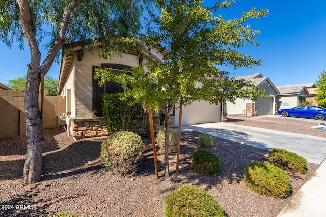 1952 N 212th Ln, Buckeye, AZ 85396 - obstructed view of property featuring stucco siding, fence, driveway, and a garage
