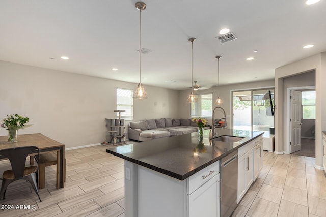 1952 N 212th Ln, Buckeye, AZ 85396 - kitchen featuring dark countertops, a sink, plenty of natural light, baseboards, and visible vents