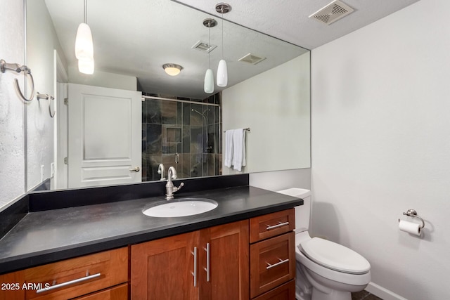 full bath with toilet, vanity, a shower stall, and visible vents