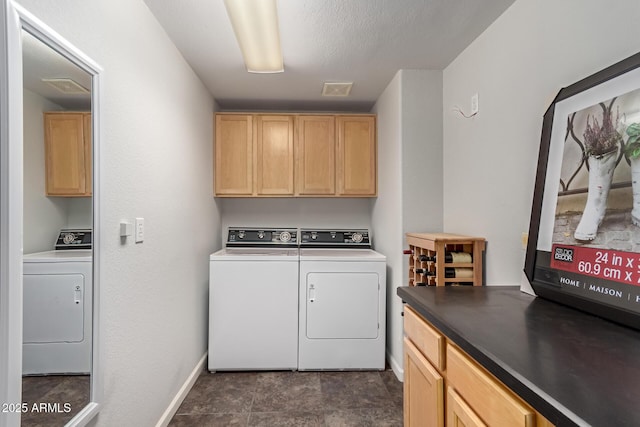 laundry room featuring visible vents, washing machine and dryer, cabinet space, and baseboards