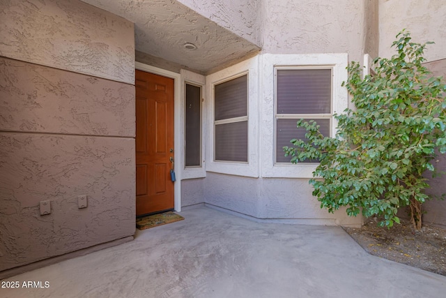 property entrance with stucco siding