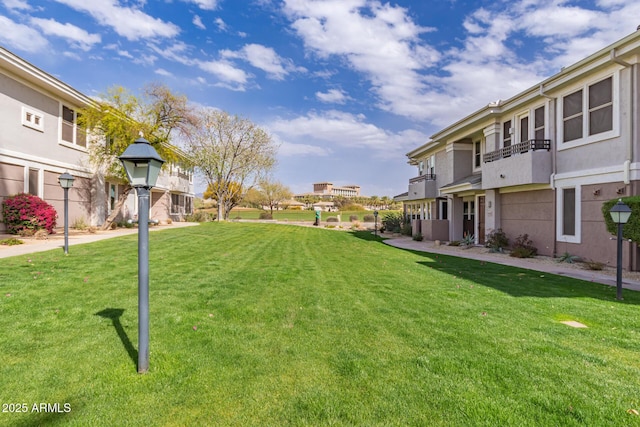 view of community with a residential view and a yard