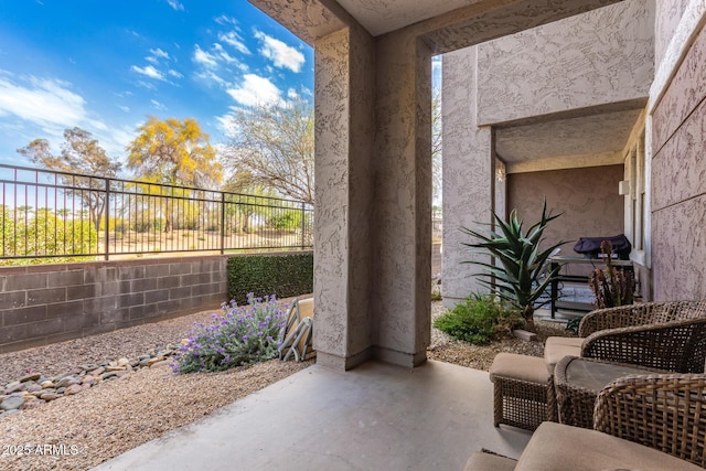 view of patio / terrace featuring fence