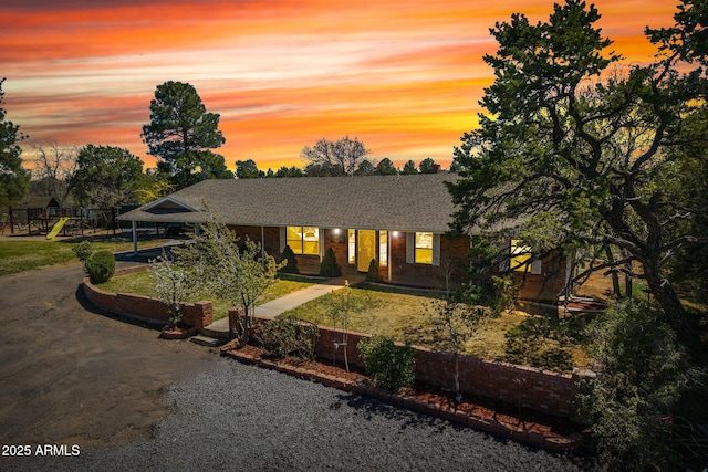 541 W Deuce Of Clubs, Show Low, AZ 85901 - view of front of home with a yard, brick siding, a shingled roof, driveway, and a playground