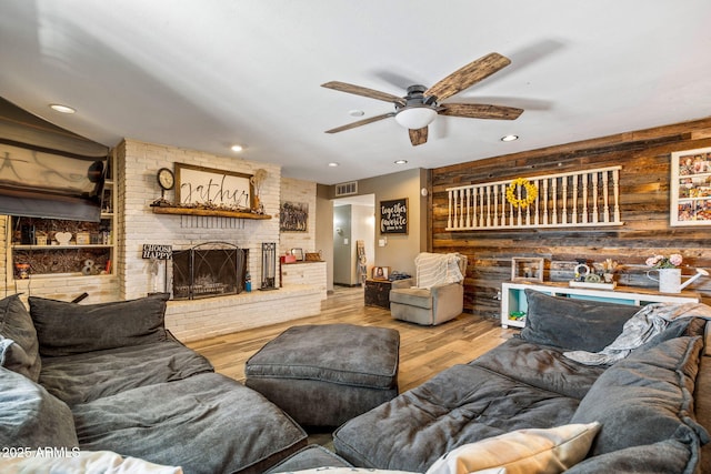 541 W Deuce Of Clubs, Show Low, AZ 85901 - living room featuring wood walls, recessed lighting, a fireplace, wood finished floors, and a ceiling fan