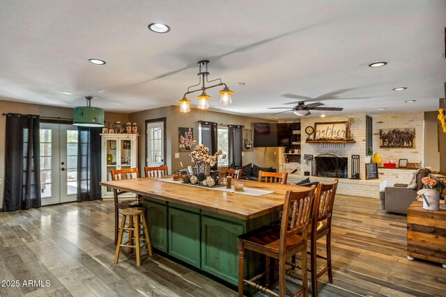 541 W Deuce Of Clubs, Show Low, AZ 85901 - dining space with a fireplace, recessed lighting, a ceiling fan, and dark wood-type flooring